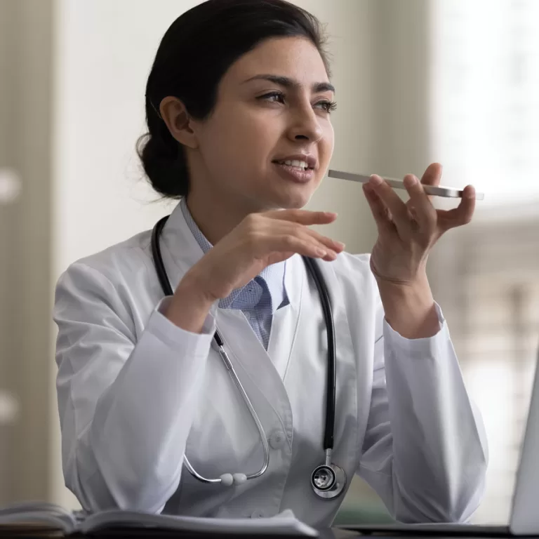Doctor using Dragon Medical One for professional speech recognition and dictation