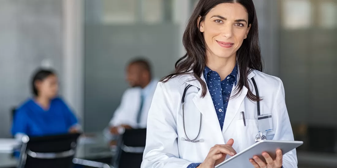 Doctor using Dragon Medical One for medical speech recognition and dictation for Canadian Healthcare Documentation